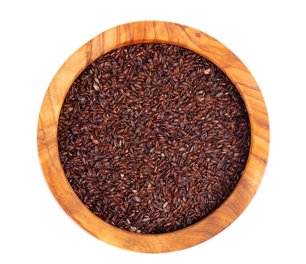 Psyllium seeds in wooden bowl isolated on white background Plantain Plantago psyllium Top view