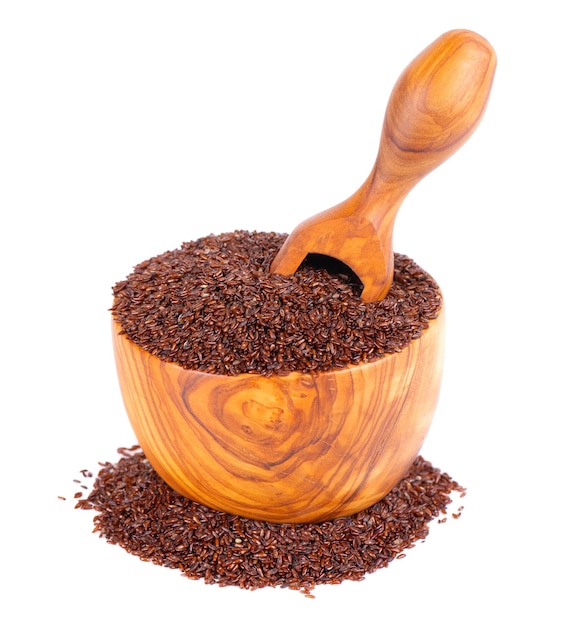 Psyllium seeds in wooden bowl and spoon isolated on white background Plantain Plantago psyllium