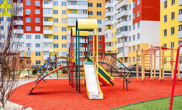 Public colorful children playground for kids activities with new houses on surface