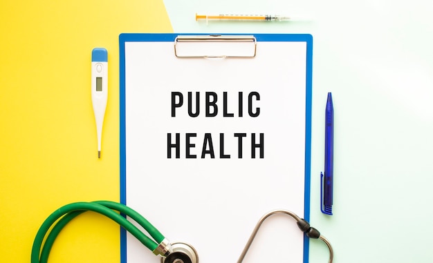 PUBLIC HEALTH text on a letterhead in a medical folder on a beautiful surface. Stethoscope, thermometer and pen.