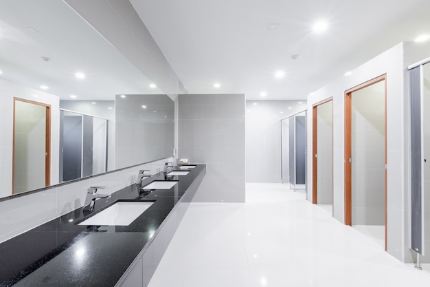 Public Interior of bathroom with sink basin faucet lined