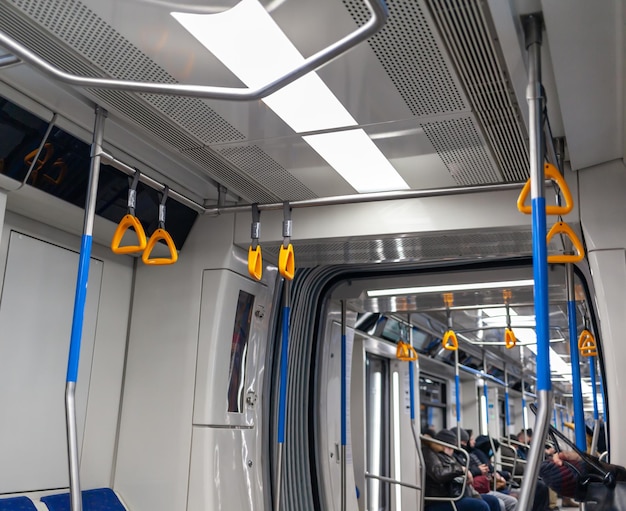 Public transport in the city Yellow handrails for hands closeup modern subway car