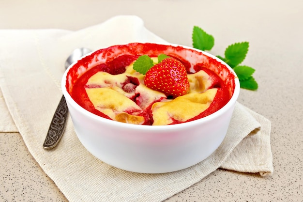 Pudding strawberry in bowl on stone table