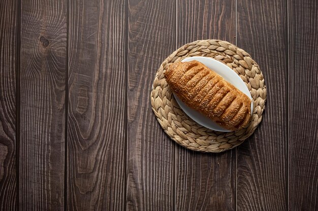 Puff pastry bun with sesame and condensed milk, homemade cakes and sweets, pastries for tea