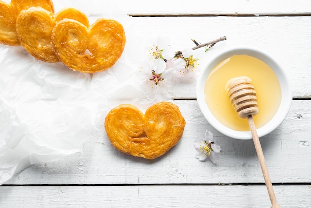 Puff pastry palms with honey Dessert with flour sugar honey egg for breakfast industrial homemade