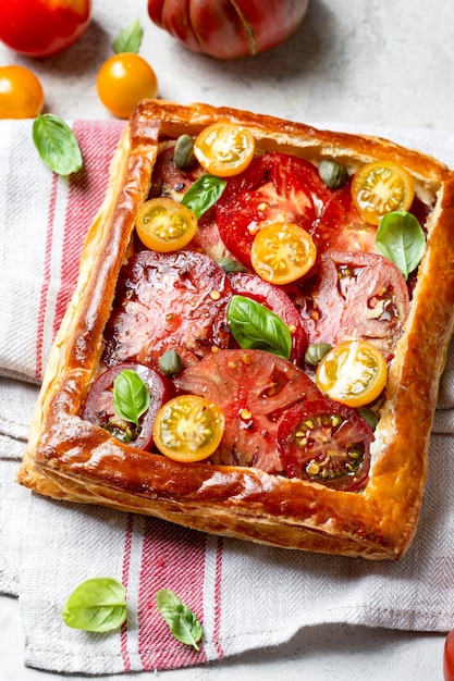 Puff pastry pie with tomatoes and basil