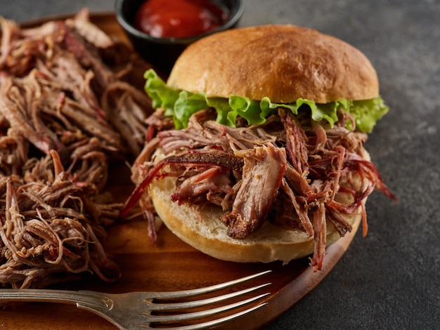 Pulled pork burger Burger with pork meat on a wooden board