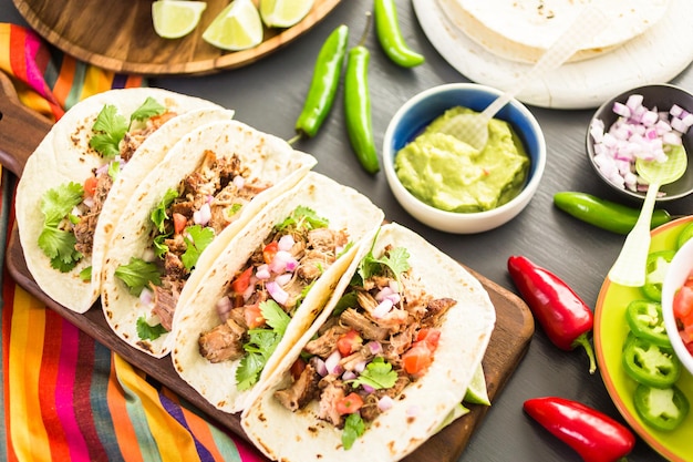 Pulled pork carnitas with pico de gallo on a flour tortilla.