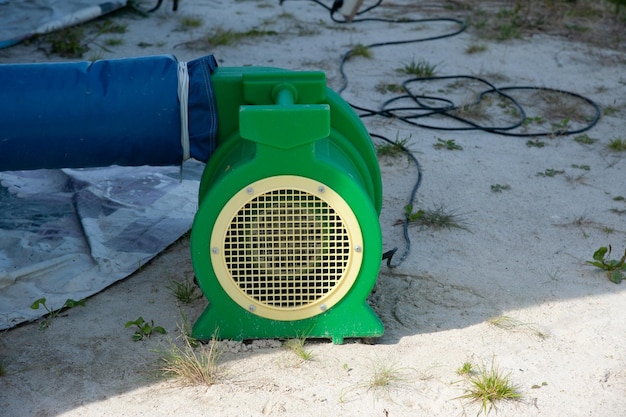 the pump for inflating the trampoline is on the sand