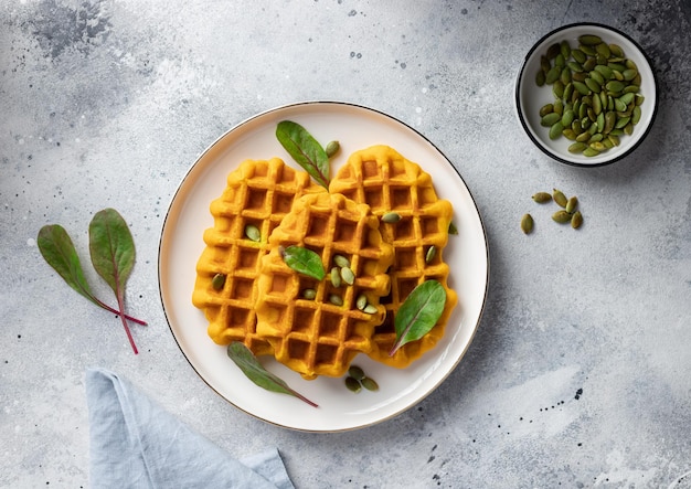 Pumpkin Belgian waffles on white plate