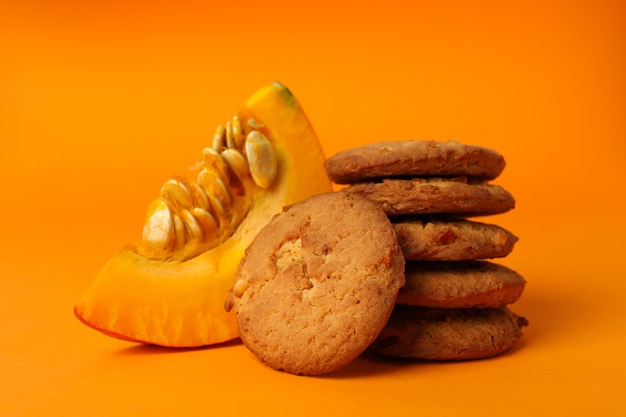 Pumpkin cookies on orange background, close up.