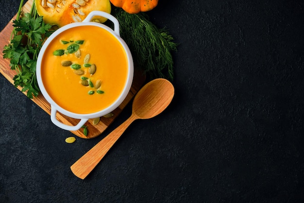 Pumpkin cream soup with pumpkin seeds served