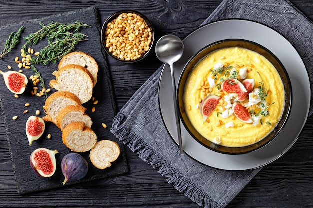 Pumpkin cream soup with thyme with feta and figs