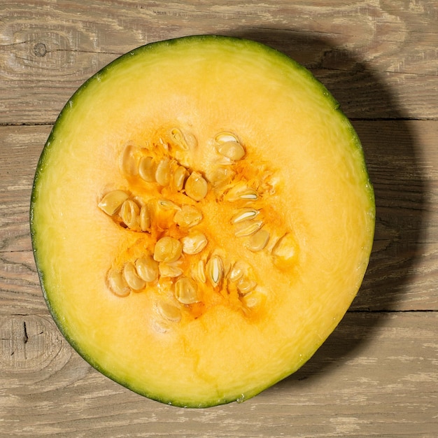 Pumpkin cut in half on wooden background flat lay