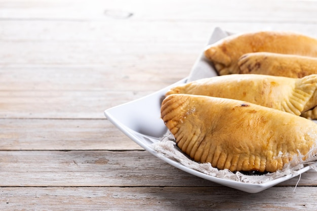 Pumpkin empanadillas for Halloween or Thanksgivings Day on wooden table