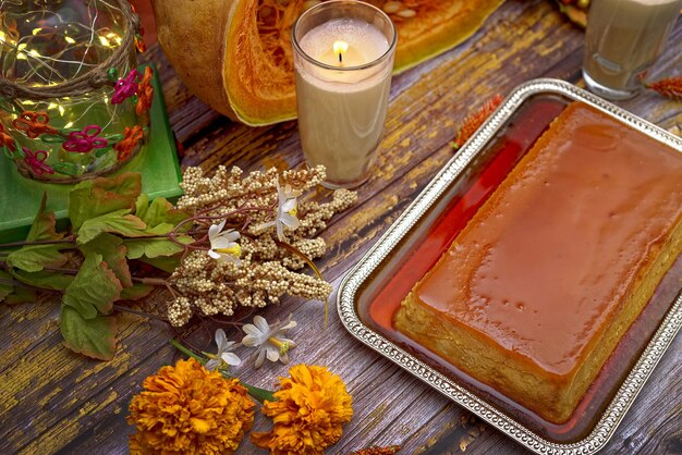 Pumpkin flan dessert made for the Day of the Dead Dessert on wooden table