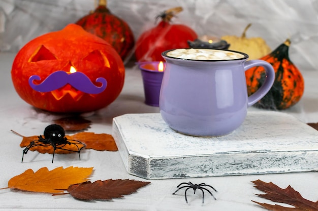 Pumpkin for Halloween with a mug of coffee and cookies on the background of a wall with ghosts bats spiders candles pumpkins leaves Selective focus