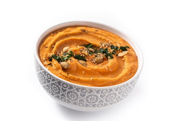 Pumpkin hummus in bowl isolated on white