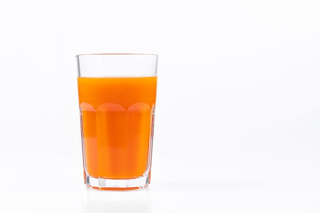 Pumpkin juice in transparent glass isolated on white background Vegetable vegetarian drink Healthy food and diet