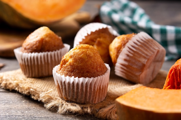 Pumpkin muffins on rustic wooden table. Autumn dessert