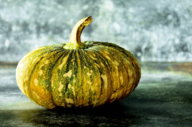 Pumpkin on old glass desk in kitchen room