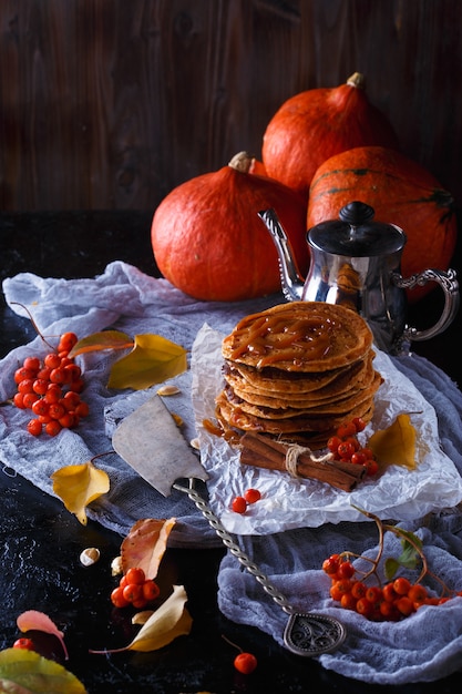 Pumpkin pancakes with caramel topping, with pumpkins, leaves  .