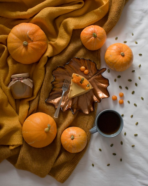 Pumpkin pastries cheesecake and a drink on the bed