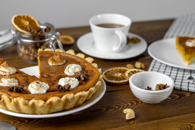 Pumpkin pie on rustic wooden background