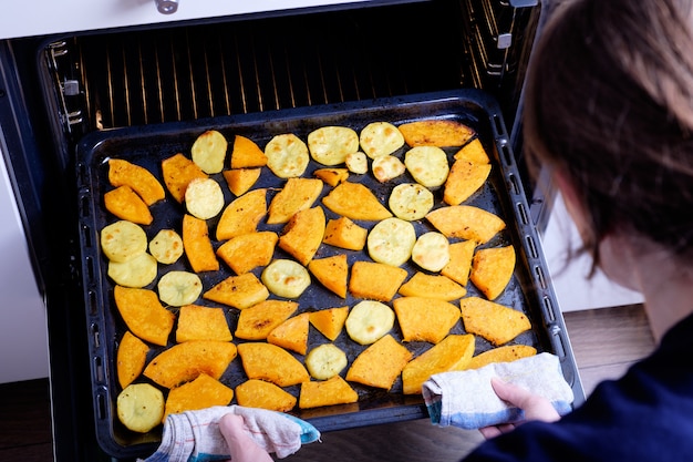 Pumpkin and potatoes on a baking tray