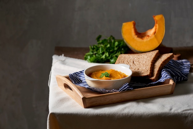 Pumpkin puree on a rustic wooden table.