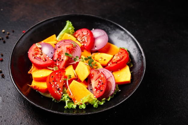 Pumpkin salad vegetables tomato mix fresh meal snack on the table copy space food background rustic