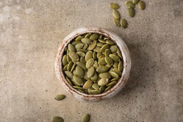 Pumpkin seeds in a bowl superfoods Copy space