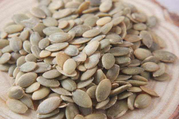 pumpkin seeds in a small bowl on black background