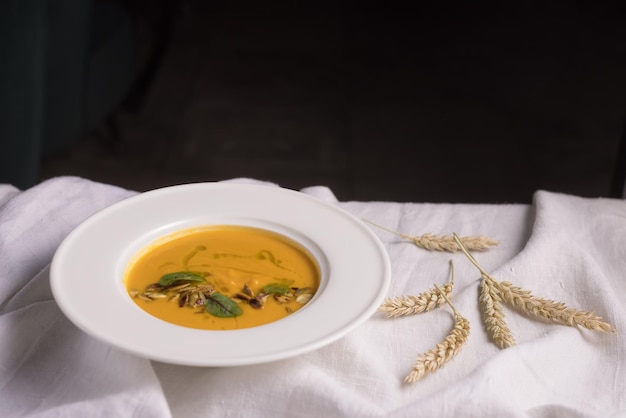 Pumpkin soup on a light background healthy food concept