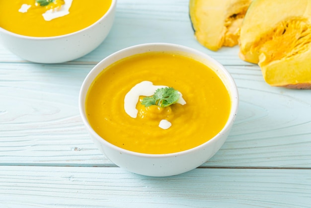 Pumpkin soup in white bowl