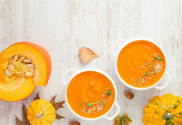 Pumpkin soup with croutons on white wooden background Copy space directly above