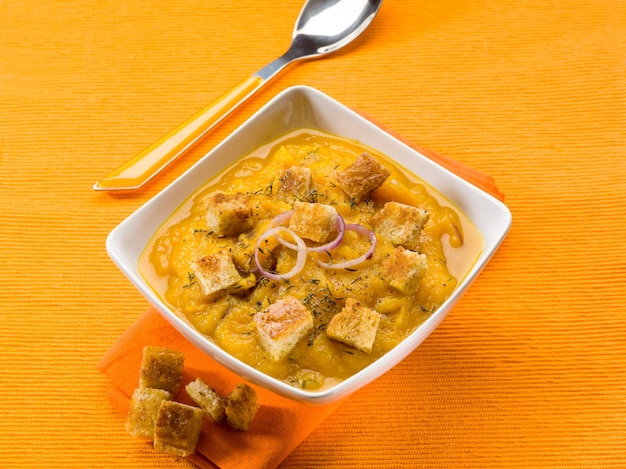 Pumpkin soup with sliced toasted bread