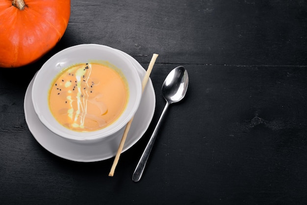 Pumpkin Soup On a wooden surface Top view Free space for your text