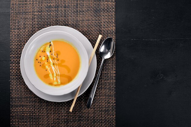 Pumpkin Soup On a wooden surface Top view Free space for your text