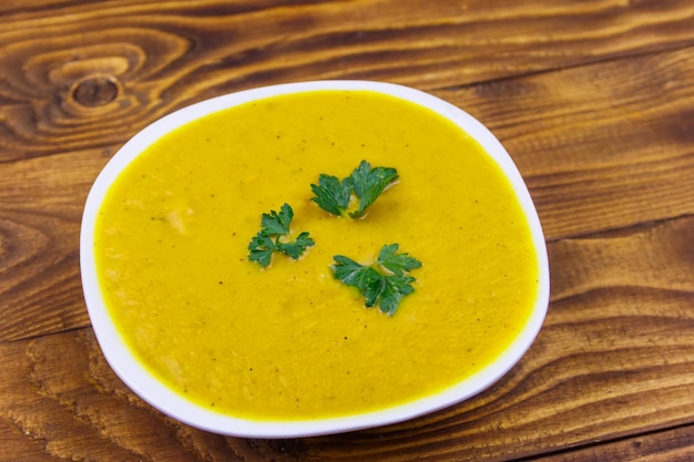 Pumpkin soup on a wooden table