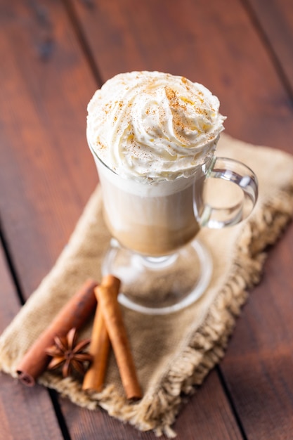 Pumpkin spice latte in a glass mug