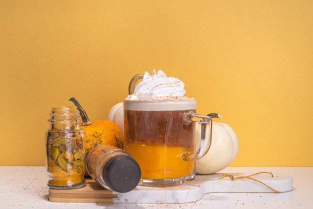 Pumpkin spice latte in a glass mug