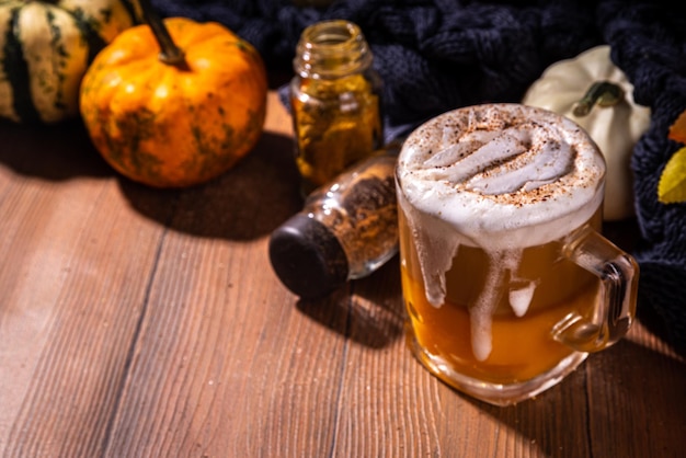 Pumpkin spice latte in a glass mug