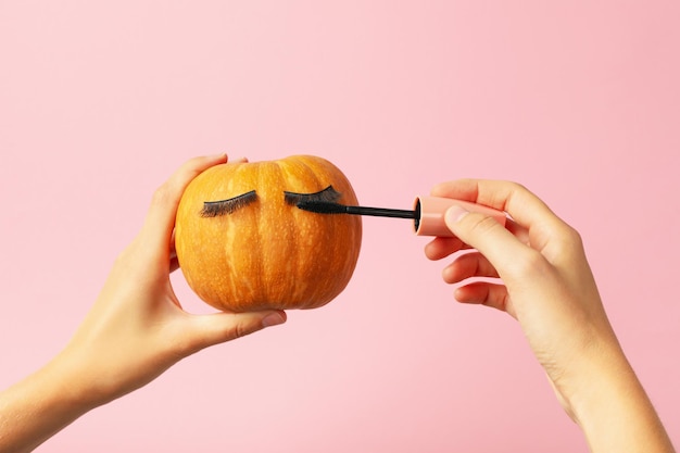 Pumpkin with eyelashes and mascara Facial skin care concept