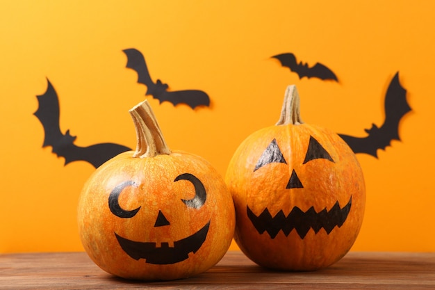 Pumpkins with painted faces on a colored background for halloween