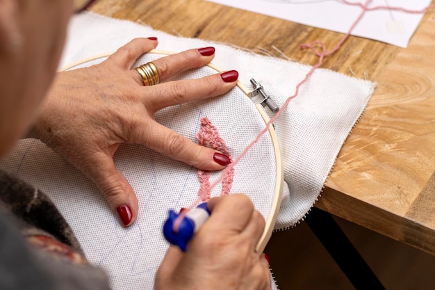 Punch needle embroidery technique Elderly woman embroidering