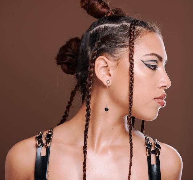 Punk fashion and woman with creative cosmetics hair style and makeup in brown studio background Young female hipster and 90s style face and bondge clothes with rock aesthetic and gen z girl