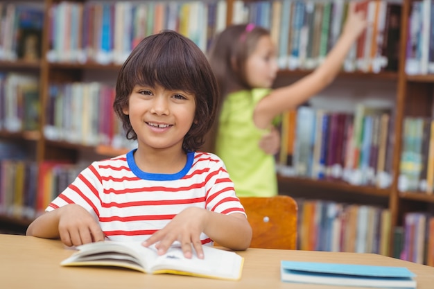 Pupil smiling at camera in library