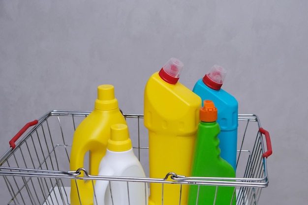 Purchase of household chemicals. Plastic bottles of household chemicals in the shopping basket.