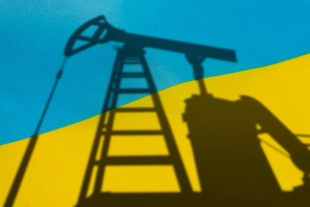 Purchase of oil in Ukraine Oil rigs on the background of the ukrainian flag Mining and oil import trading on global fuel market Fuel industry